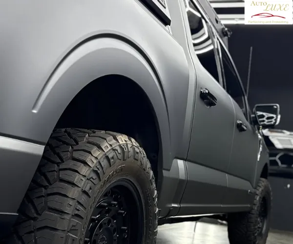 view of a luxury vehicle's hood showing a deep mirror reflection after a professional ceramic coating application