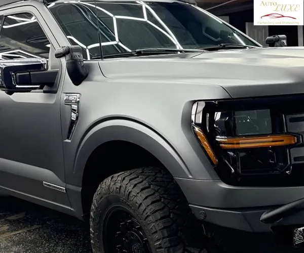 view of a luxury vehicle's hood showing a deep mirror reflection after a professional ceramic coating application