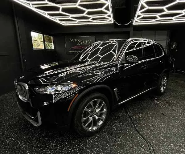 an installed automotive window tint on the side windows of a luxury vehicle