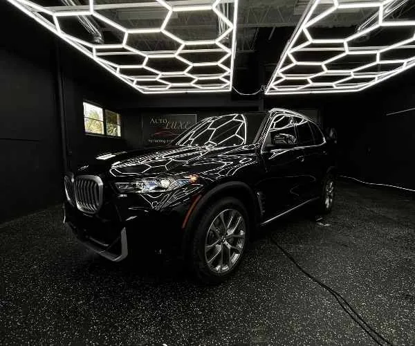 an installed automotive window tint on the side windows of a luxury vehicle